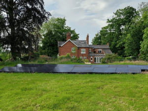 Solar panels in the grounds of a large UK detached house