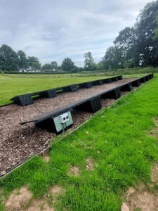 Solar panels in the grounds of a large farmhouse