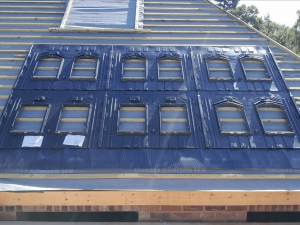 The beginning of the installation of solar panels on a roof being constructed