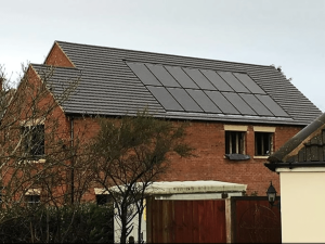 Solar panels on the roof of a large detached house