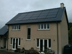 Solar panels on the roof of a large detached house