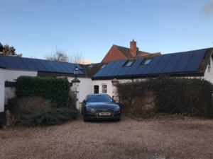 Solar panels on the roof of a white farmhouse