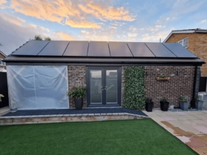 Solar panels on the roof of a one-storey garden building